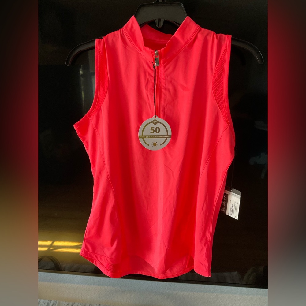 Bright orange sleeveless golf top with quarter zip